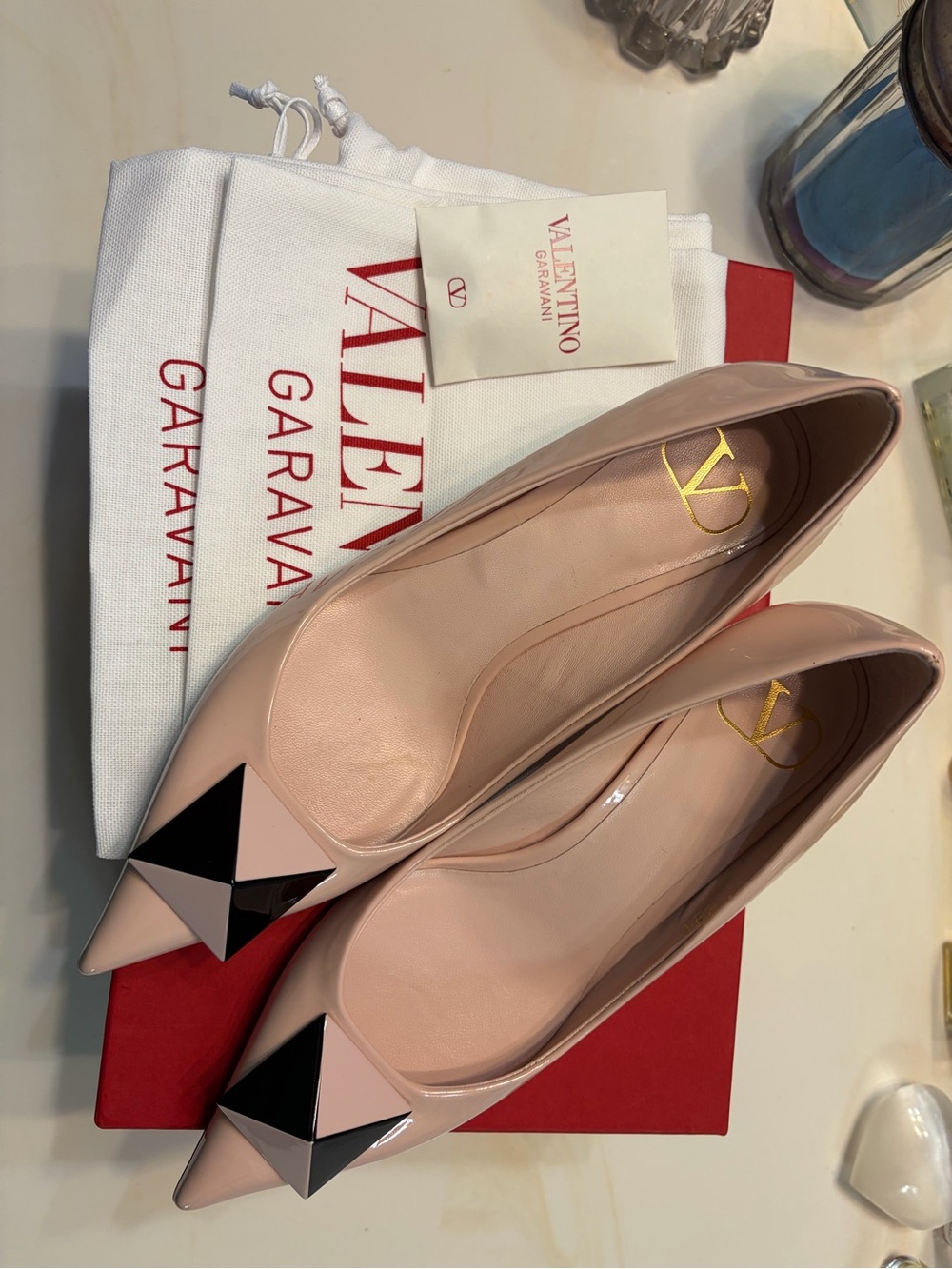 Valentino Garavani Pink Patent Leather Pointed Toe Flats with Large Rockstud.